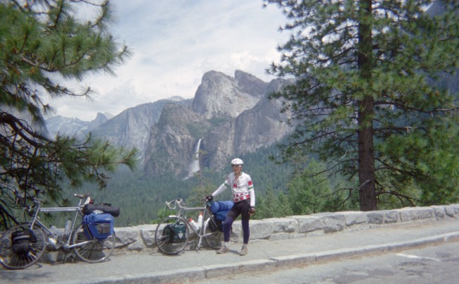 Frank standing by our bikes at vista point overlooking Yosemite Valley.
