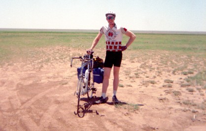 Alan standing with bike in delosate field