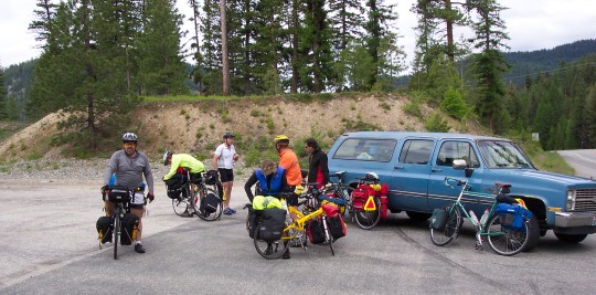 Group of cyclists around a station wagon
