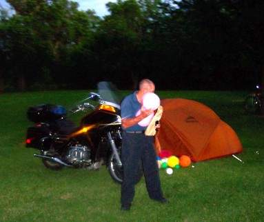Bill dealing with baloons, motorcycle in background