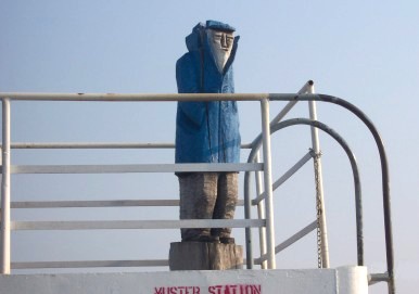 Statue of seaman up on a parapet