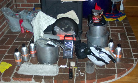 Camping gear spread out on the hearth