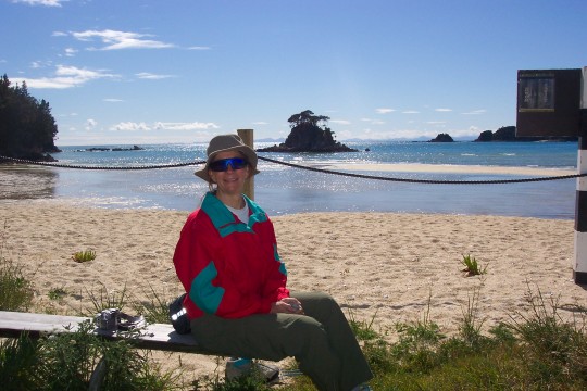 Sue sitting on a bench at Torrent Bay