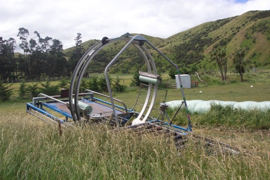 Hay baling machine sitting in a field