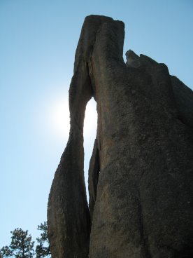 Up-jutting rock with a hole in it like a needle