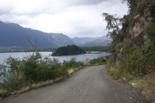Gravel road with lake in background