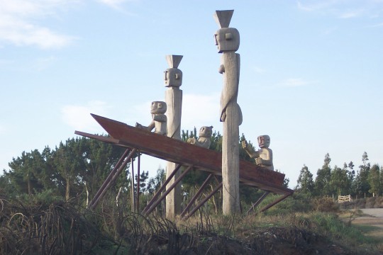 Wooden statues beside the road