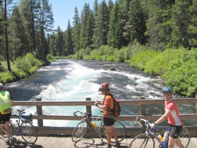 Cyclists on bridge over the Metolius River 'falls' (more like rapids)