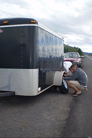 Changing a trailer tire by the side of the road