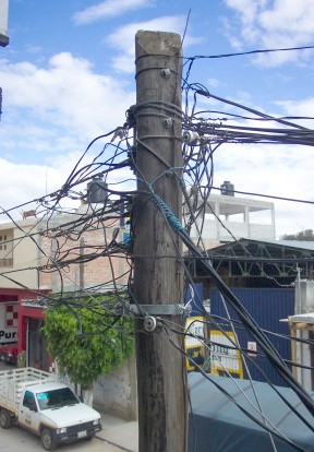 Jumble of wires at top of telephone pole