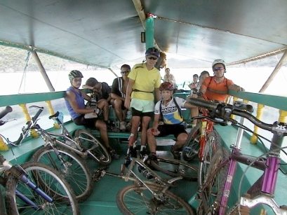 Cyclists and bikes crowded under the awning of the pump boar