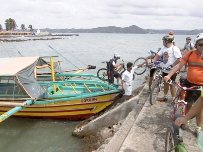 Unloading bikes from pump boat to the concrete breakwater/pier