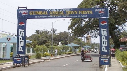 Banner over street: 'Guimbal Annual Town Fiesta'