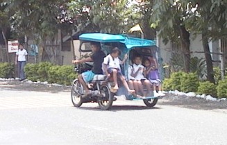 Three-wheeled motorcycle with several people in passenger compartment