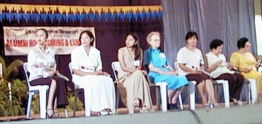 The contestants seated on the stage, Mom in the middle