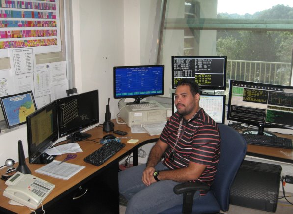 Efrain at desk with monitors