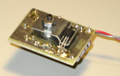 Photo of bottom of board, showing clamp and sensor